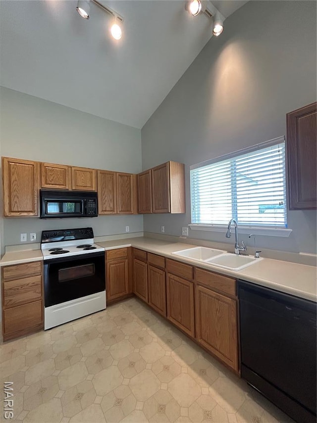 2401 Mountain Range Ct, Pacific, MO 63069 - kitchen with black appliances, rail lighting, high vaulted ceiling, and light countertops
