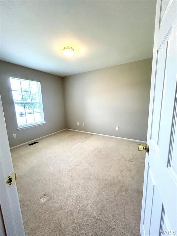 2401 Mountain Range Ct, Pacific, MO 63069 - carpeted empty room with baseboards