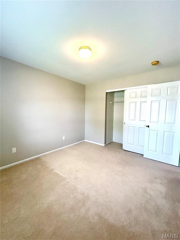 2401 Mountain Range Ct, Pacific, MO 63069 - unfurnished bedroom featuring light colored carpet and a closet