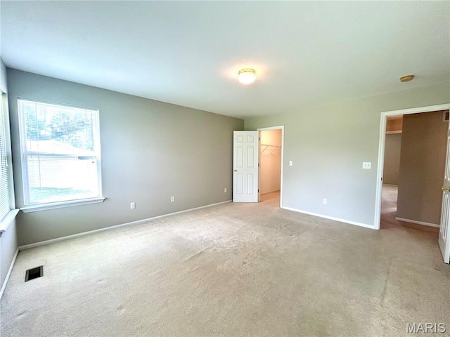 2401 Mountain Range Ct, Pacific, MO 63069 - unfurnished bedroom featuring light colored carpet, a walk in closet, and a closet