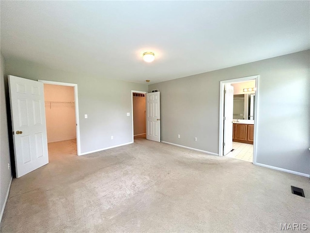 2401 Mountain Range Ct, Pacific, MO 63069 - unfurnished bedroom featuring a spacious closet, light colored carpet, connected bathroom, and a closet