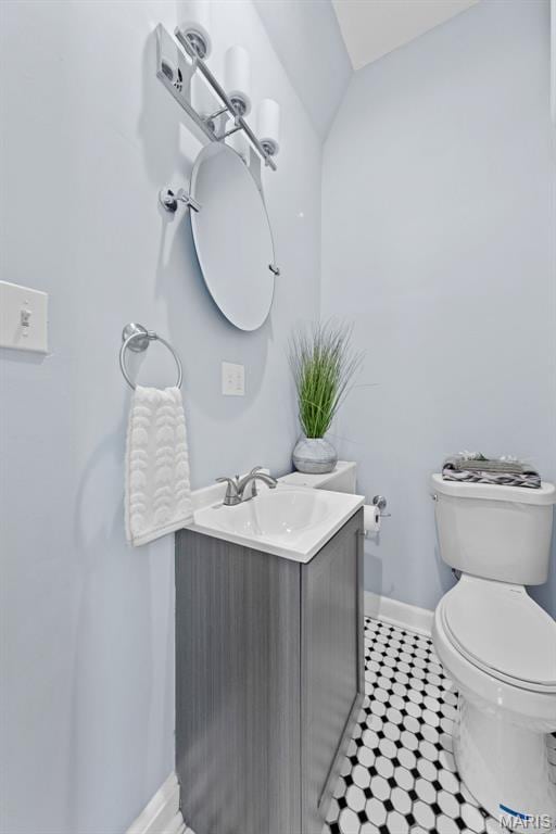 3615 Nebraska Ave, Saint Louis, MO 63118 - half bathroom with vanity, tile patterned flooring, and vaulted ceiling