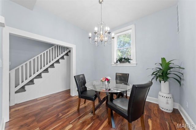 3615 Nebraska Ave, Saint Louis, MO 63118 - dining space with stairs, wood finished floors, and a chandelier