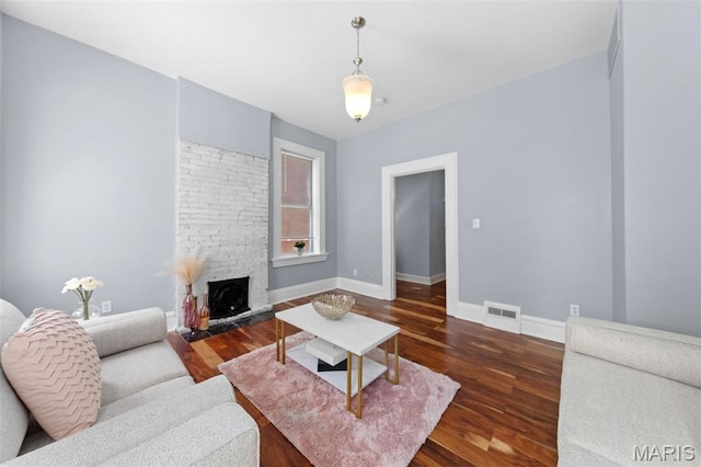 3615 Nebraska Ave, Saint Louis, MO 63118 - living area featuring wood finished floors and a fireplace with raised hearth