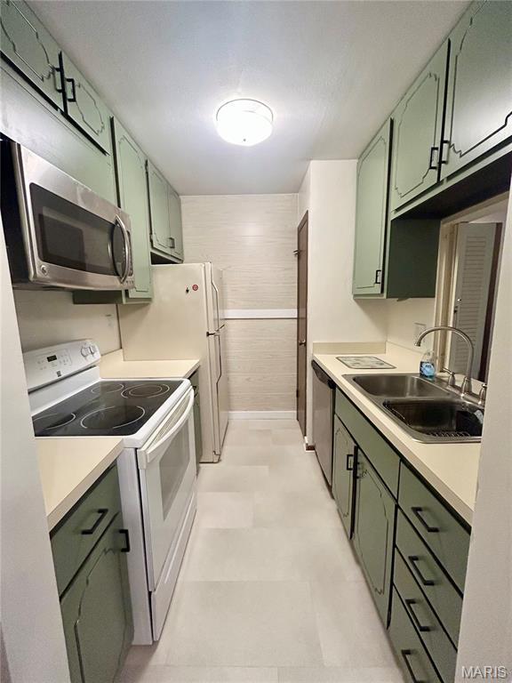 4278 Kay Ln Unit 2, Saint Louis, MO 63123 - kitchen featuring green cabinetry, appliances with stainless steel finishes, light flooring, and light countertops