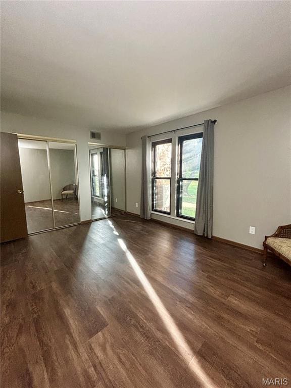 4278 Kay Ln Unit 2, Saint Louis, MO 63123 - unfurnished bedroom featuring two closets and wood finished floors