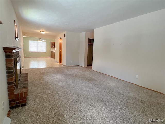 138 S 33rd St, Belleville, IL 62226 - unfurnished living room featuring light carpet, a brick fireplace, and a ceiling fan