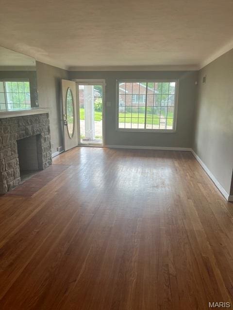 6721 Itaska St, Saint Louis, MO 63109 - unfurnished living room featuring wood finished floors, plenty of natural light, and a stone fireplace
