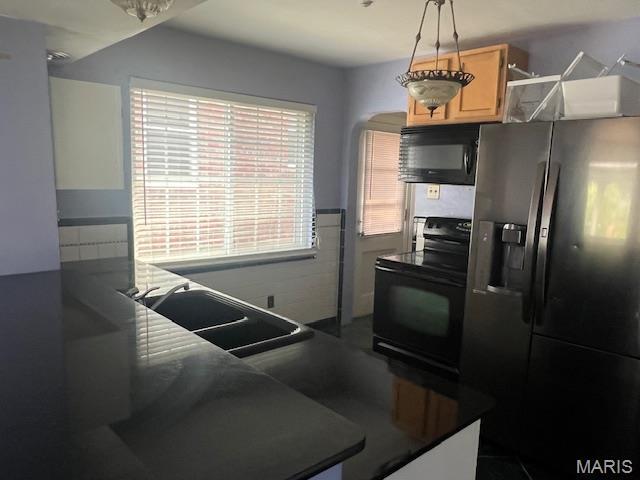 6721 Itaska St, Saint Louis, MO 63109 - kitchen with black appliances, dark countertops, and light brown cabinetry