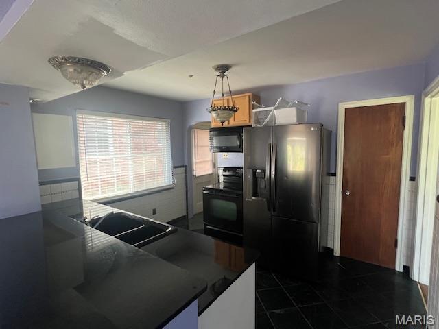 6721 Itaska St, Saint Louis, MO 63109 - kitchen featuring black appliances, dark countertops, and decorative light fixtures