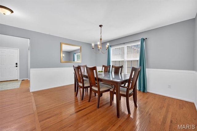 2426 Guardian Ct, Arnold, MO 63010 - dining space featuring a chandelier, wood finished floors, and plenty of natural light
