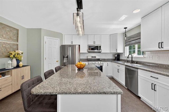 2426 Guardian Ct, Arnold, MO 63010 - kitchen with stainless steel appliances, a kitchen breakfast bar, decorative backsplash, and stone countertops