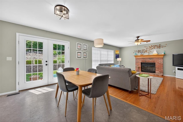 2426 Guardian Ct, Arnold, MO 63010 - dining space featuring a fireplace, french doors, and a ceiling fan