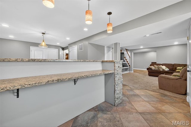 2426 Guardian Ct, Arnold, MO 63010 - kitchen with stone finish floors, a breakfast bar, pendant lighting, recessed lighting, and light stone counters