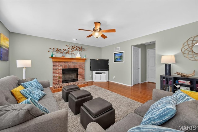 2426 Guardian Ct, Arnold, MO 63010 - living room with a ceiling fan, wood finished floors, and a brick fireplace