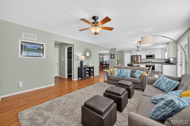 2426 Guardian Ct, Arnold, MO 63010 - living room with light wood-style floors and a ceiling fan