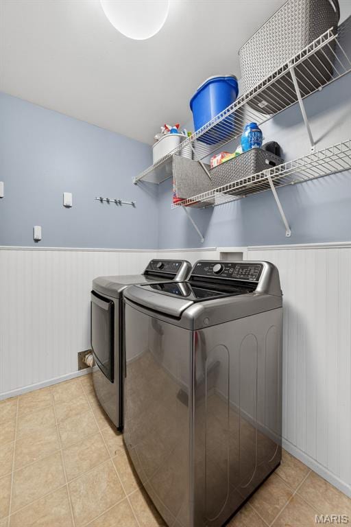2426 Guardian Ct, Arnold, MO 63010 - laundry room with washer and dryer, a wainscoted wall, and light tile patterned flooring