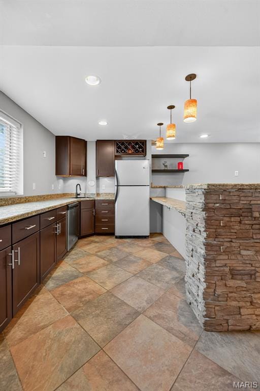 2426 Guardian Ct, Arnold, MO 63010 - kitchen with freestanding refrigerator, dishwasher, dark brown cabinetry, hanging light fixtures, and a peninsula