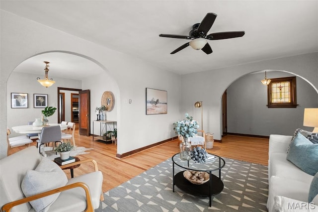 4932 Fairview Ave, Saint Louis, MO 63139 - living area featuring arched walkways, wood finished floors, and ceiling fan