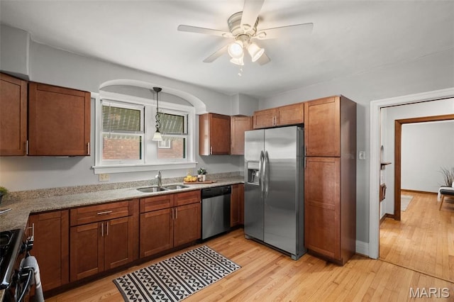 4932 Fairview Ave, Saint Louis, MO 63139 - kitchen featuring appliances with stainless steel finishes, a ceiling fan, light wood-type flooring, and brown cabinetry