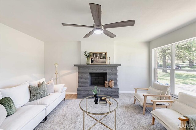 7315 Cheshire Ln, Affton, MO 63123 - living room featuring wood finished floors, ceiling fan, and a fireplace