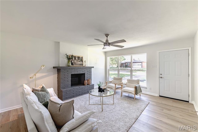 7315 Cheshire Ln, Affton, MO 63123 - living area with wood finished floors, a fireplace, and a ceiling fan