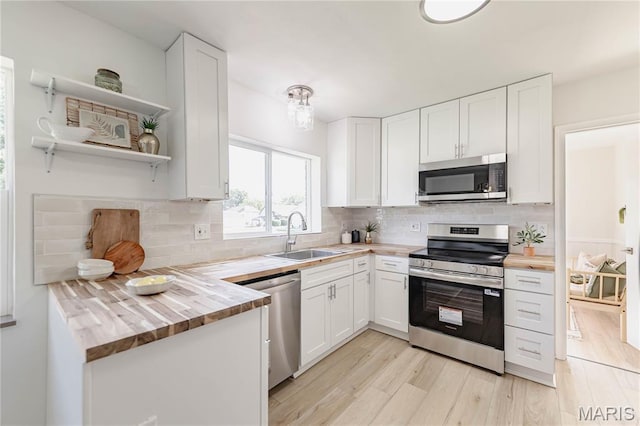 7315 Cheshire Ln, Affton, MO 63123 - kitchen featuring appliances with stainless steel finishes, butcher block countertops, and white cabinets