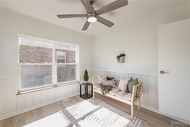 7315 Cheshire Ln, Affton, MO 63123 - sitting room with wood finished floors, a wainscoted wall, and ceiling fan