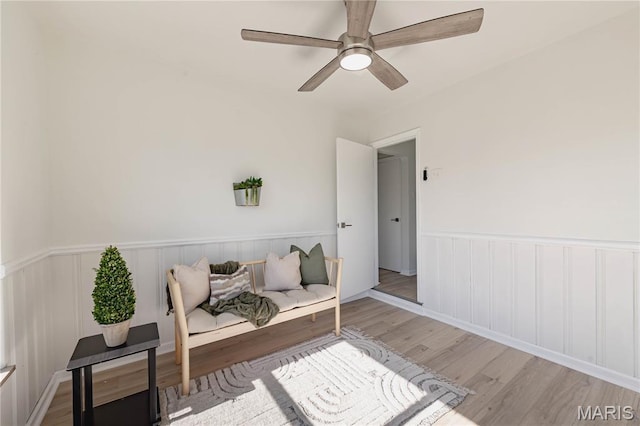 7315 Cheshire Ln, Affton, MO 63123 - sitting room featuring wood finished floors, a wainscoted wall, and ceiling fan