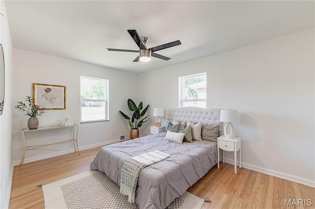 7315 Cheshire Ln, Affton, MO 63123 - bedroom featuring multiple windows, wood finished floors, and ceiling fan