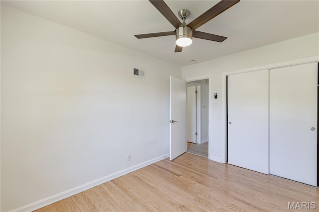 7315 Cheshire Ln, Affton, MO 63123 - unfurnished bedroom with light wood-style floors, a closet, and ceiling fan