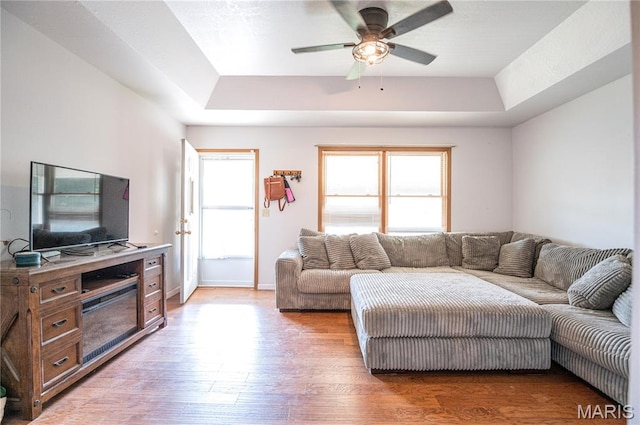 921 Mallard Sq, Rolla, MO 65401 - living area featuring a tray ceiling, a ceiling fan, and light wood finished floors