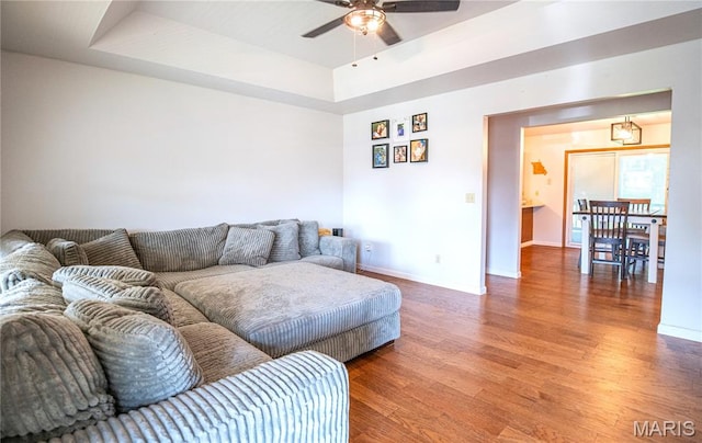 921 Mallard Sq, Rolla, MO 65401 - living area featuring wood finished floors, ceiling fan, and a raised ceiling