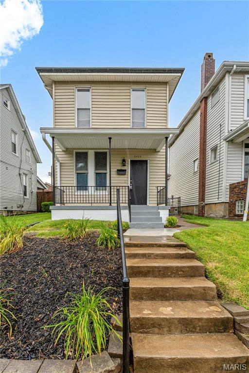 2725 Macklind Ave, Saint Louis, MO 63139 - american foursquare style home with covered porch and a front lawn