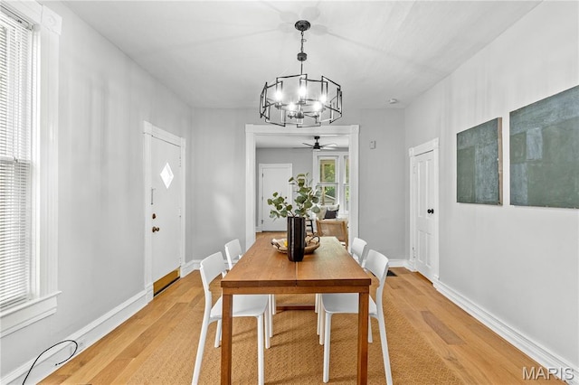 2725 Macklind Ave, Saint Louis, MO 63139 - dining room featuring a chandelier, light wood-style flooring, and ceiling fan