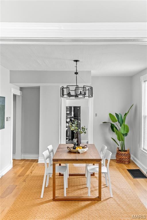 2725 Macklind Ave, Saint Louis, MO 63139 - dining area featuring light wood finished floors and a chandelier