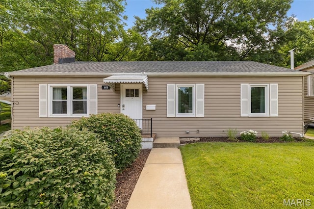 608 N Laclede Station Rd, Webster Groves, MO 63119 - view of front of house featuring a front lawn, a chimney, and roof with shingles