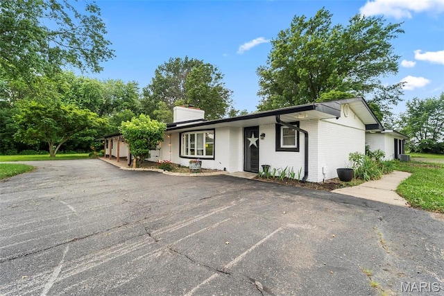 8114 Montclaire Ave, Brighton, IL 62012 - ranch-style house with brick siding and a chimney