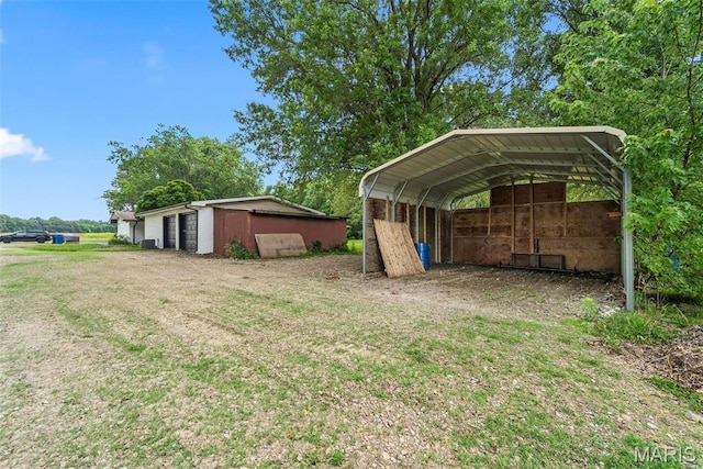 8114 Montclaire Ave, Brighton, IL 62012 - view of grassy yard featuring a detached carport and an outbuilding