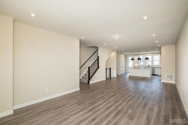 1347 W Gateway Hts W Unit 53-603, Richmond Heights, MO 63144 - unfurnished living room featuring dark wood-type flooring, stairway, and recessed lighting
