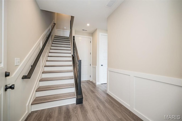 1347 W Gateway Hts W Unit 53-603, Richmond Heights, MO 63144 - stairway featuring wood finished floors, wainscoting, recessed lighting, and a decorative wall