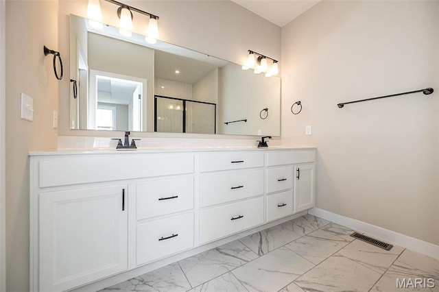 1347 W Gateway Hts W Unit 53-603, Richmond Heights, MO 63144 - bathroom with marble look tile flooring, double vanity, and an enclosed shower
