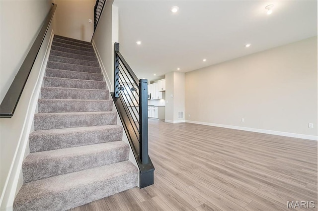 1347 W Gateway Hts W Unit 53-603, Richmond Heights, MO 63144 - stairway with wood finished floors and recessed lighting