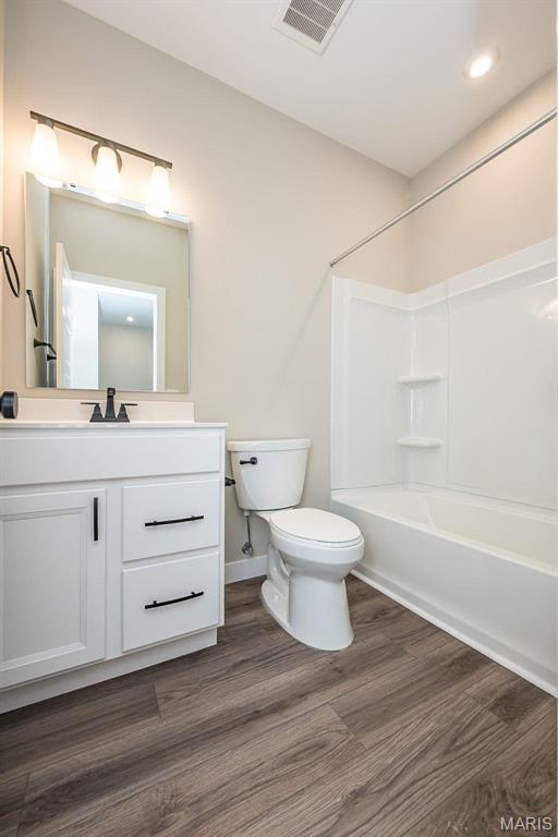 1347 W Gateway Hts W Unit 53-603, Richmond Heights, MO 63144 - bathroom with vanity, wood finished floors, shower / washtub combination, and recessed lighting