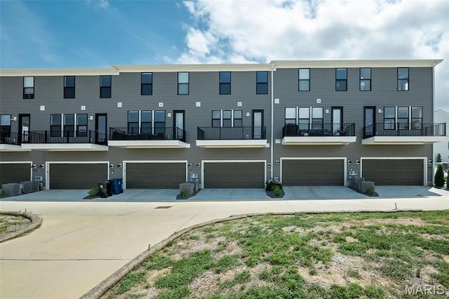 1347 W Gateway Hts W Unit 53-603, Richmond Heights, MO 63144 - back of house with an attached garage and driveway