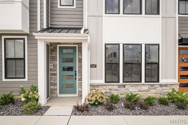 1347 W Gateway Hts W Unit 53-603, Richmond Heights, MO 63144 - doorway to property with stone siding, a standing seam roof, and a metal roof