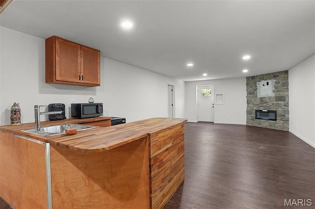 8224 Wild Acre Meadows Dr, Hillsboro, MO 63050 - kitchen featuring butcher block counters, black microwave, dark wood-style floors, recessed lighting, and brown cabinets