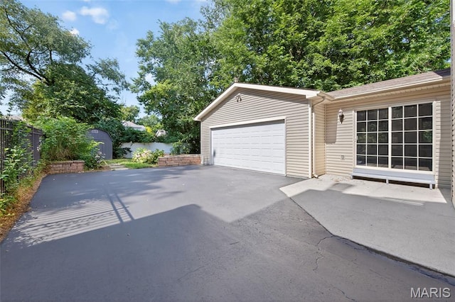 432 Clark Ave, Webster Groves, MO 63119 - garage featuring asphalt driveway and a storage unit