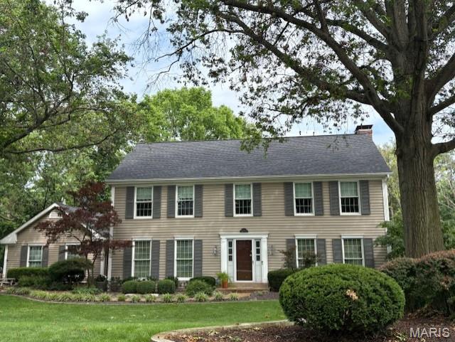 1645 Tradd Ct, Chesterfield, MO 63017 - colonial inspired home with a chimney and a front lawn
