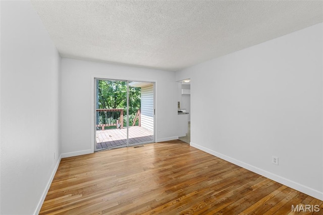2315 Bramble Ln, Florissant, MO 63033 - unfurnished room featuring light wood-style floors and a textured ceiling